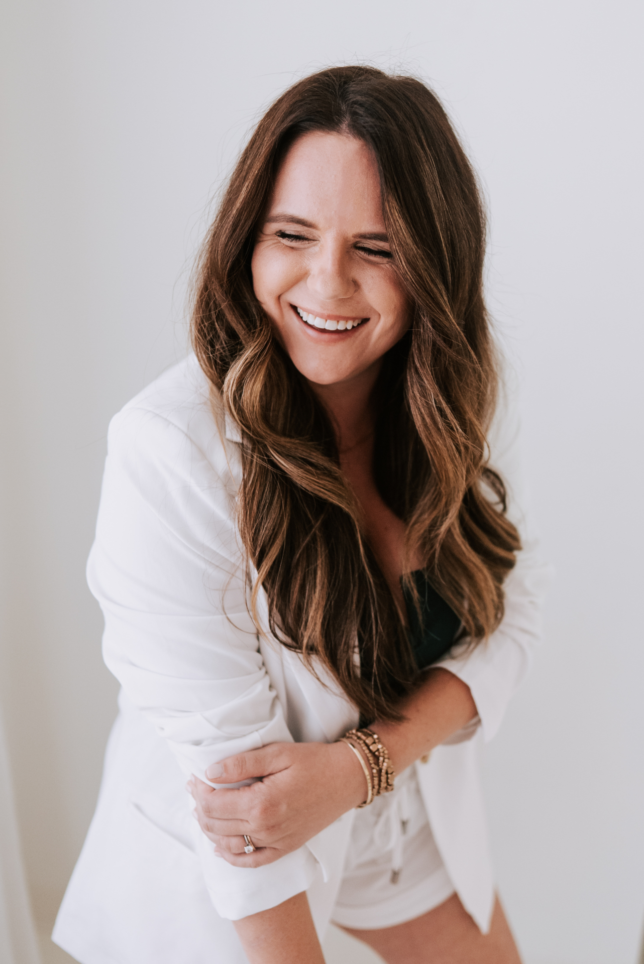 Portrait of practitioner smiling in a white blazer